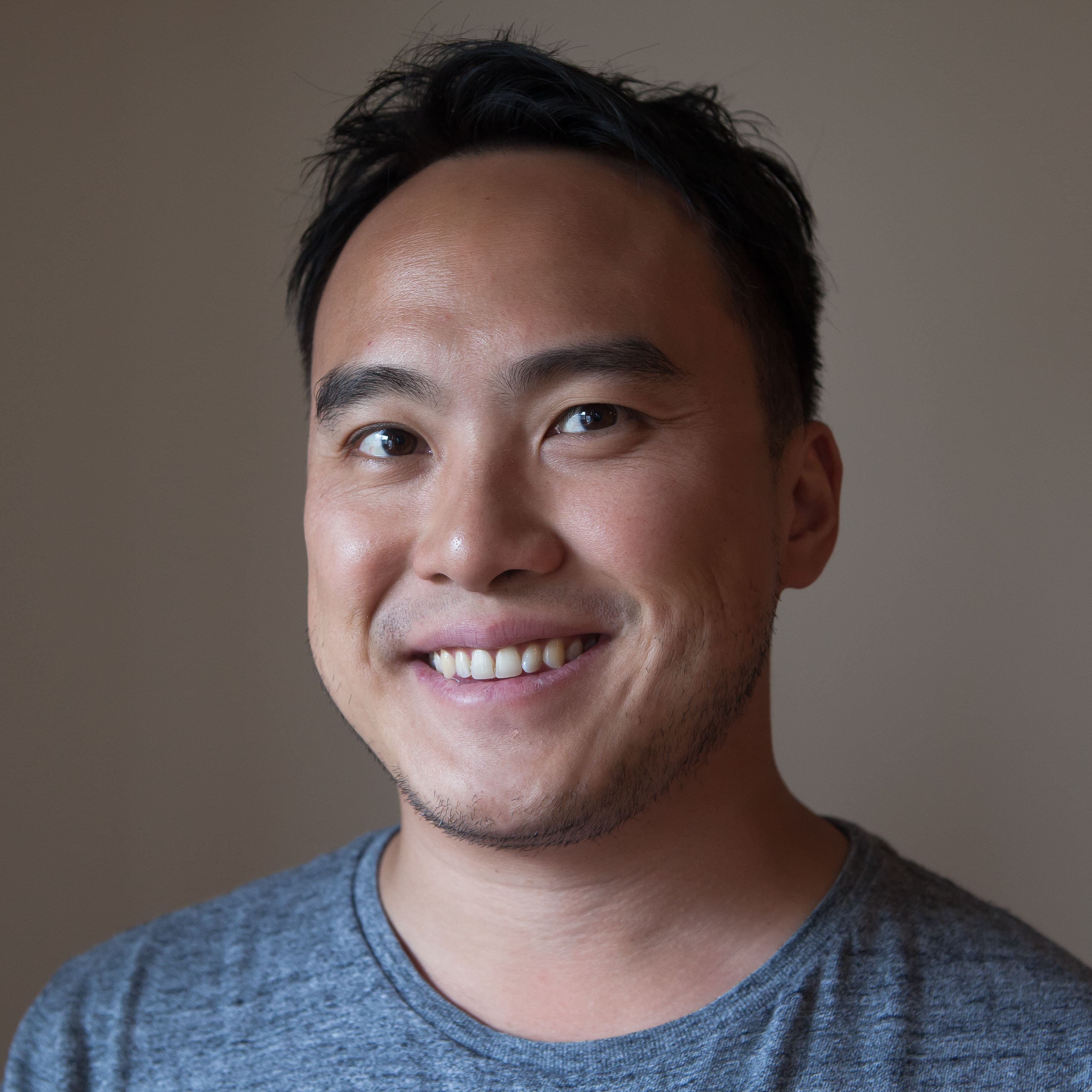 Mike Lee smiling, studio headshot